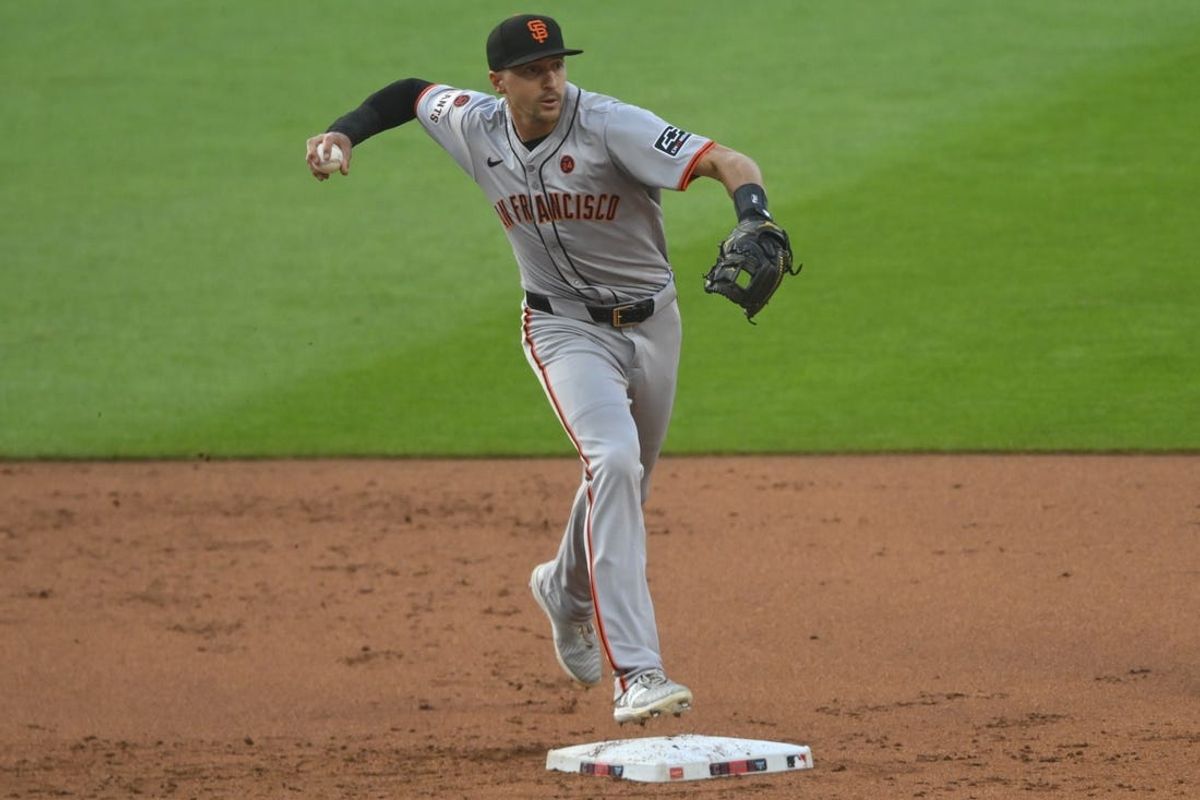 Jul 5, 2024; Cleveland, Ohio, USA; San Francisco Giants shortstop Nick Ahmed (16) turns a double play in the first inning against the Cleveland Guardians at Progressive Field. Mandatory Credit: David Richard-USA TODAY Sports