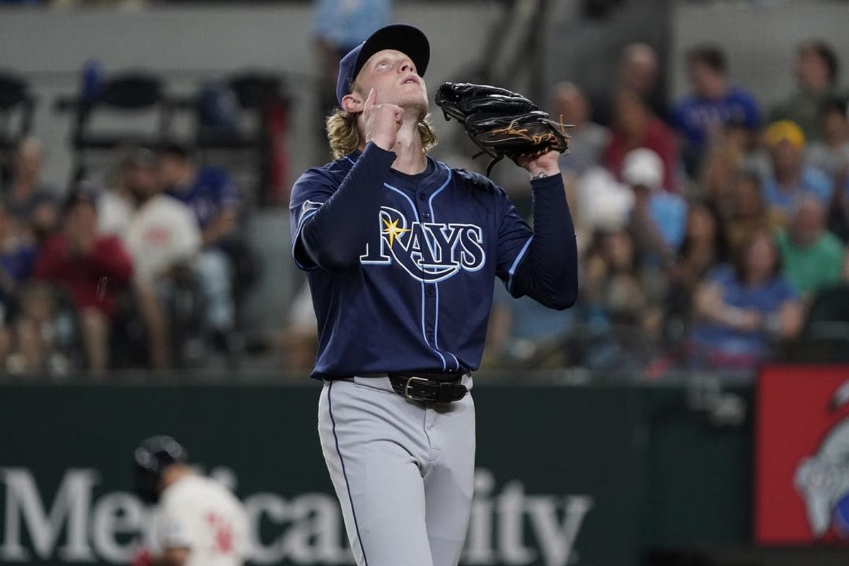 Jul 5, 2024; Arlington, Texas, USA; Tampa Bay Rays pitcher Shane Baz (11) points skyward as he walks off the field after pitching the fifth inning against the Texas Rangers at Globe Life Field. Mandatory Credit: Raymond Carlin III-USA TODAY Sports