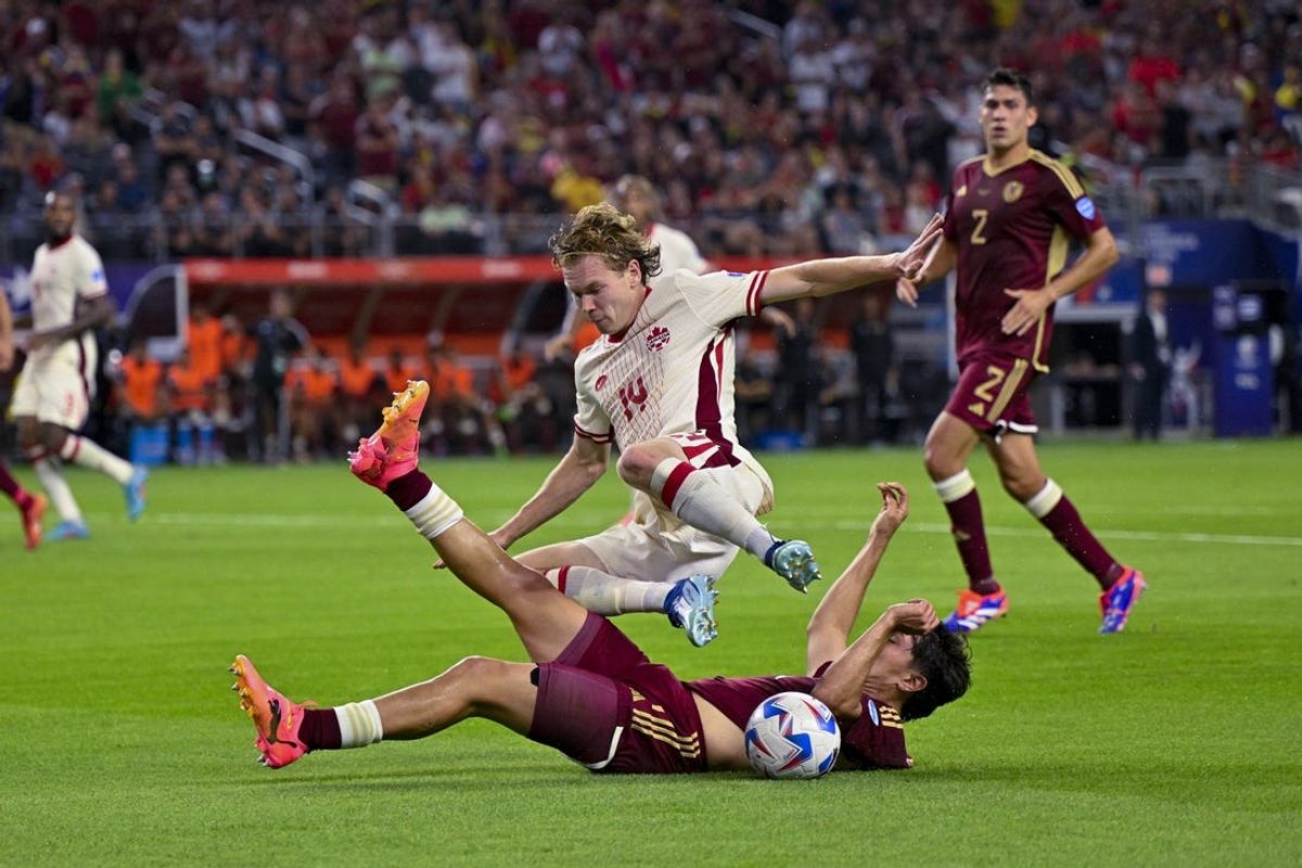 Jul 5, 2024; Arlington, TX, USA; Venezuela defender Jon Mikel Aramburu (4) knocks the ball away from Canada forward Jacob Shaffelburg (14) during the first half in the 2024 Copa America quarterfinal at AT&T Stadium. Mandatory Credit: Jerome Miron-USA TODAY Sports