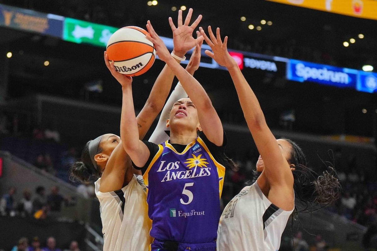 Jul 5, 2024; Los Angeles, California, USA; LA Sparks forward Dearica Hamby (5) shoots the ball against Las Vegas Aces center A'ja Wilson (22) and center Kiah Stokes (41) in the first half at Crypto.com Arena. Mandatory Credit: Kirby Lee-USA TODAY Sports