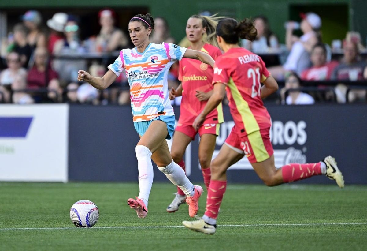 Jul 5, 2024; Portland, Oregon, USA; San Diego Wave FC forward Alex Morgan (13) dribbles against Portland Thorns FC midfielder Jessie Fleming (21) during the first half at Providence Park. Mandatory Credit: Troy Wayrynen-USA TODAY Sports