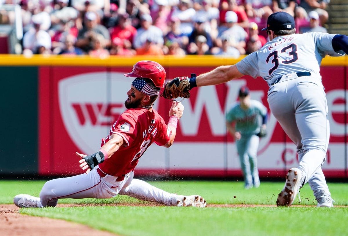 Cincinnati Reds outfielder Nick Martini (23) is tagged out by Detroit Tigers second baseman Colt Keith (33) in the second inning at Great American Ball Park in Cincinnati on Saturday, July 6, 2024.