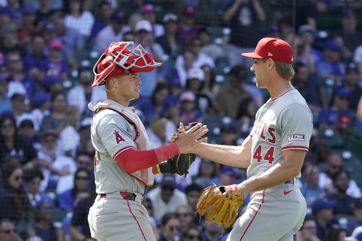 Jul 6, 2024; Chicago, Illinois, USA; Los Angeles Angels catcher Logan O'Hoppe (14) and pitcher Ben Joyce (44) celebrate their win against the Chicago Cubs at Wrigley Field. Mandatory Credit: David Banks-USA TODAY Sports