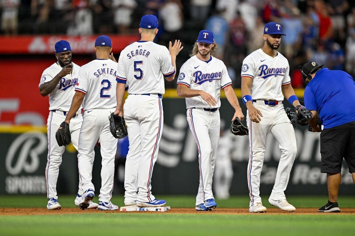 Jul 6, 2024; Arlington, Texas, USA; Texas Rangers second baseman Marcus Semien (2) and shortstop Corey Seager (5) and right fielder Adolis García (53) and left fielder Travis Jankowski (16) and center fielder Leody Taveras (3) celebrate after the Rangers defeat the Tampa Bay Rays at Globe Life Field. Mandatory Credit: Jerome Miron-USA TODAY Sports