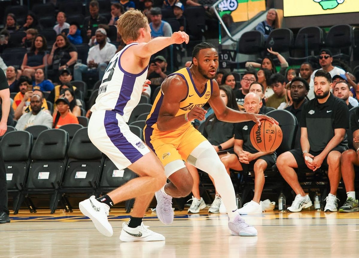 Jul 6, 2024; San Francisco, CA, USA; Los Angeles Lakers guard Bronny James Jr. (9) controls the ball against Sacramento Kings guard Dane Goodwin (33) during the third quarter at Chase Center. Mandatory Credit: Kelley L Cox-USA TODAY Sports
