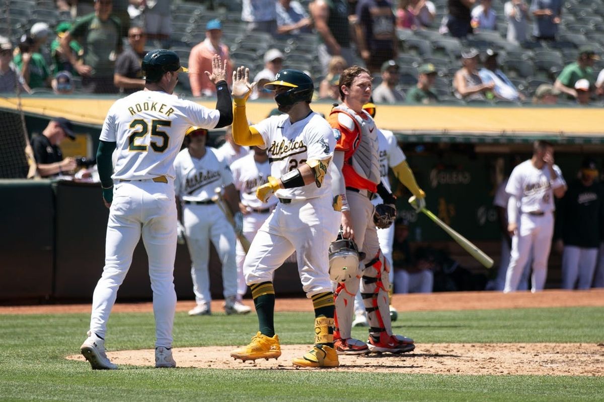 Jul 6, 2024; Oakland, California, USA; Oakland Athletics catcher Shea Langeliers (23) celebrates his two-run home run with designated hitter Brent Rooker (25) during the third inning at Oakland-Alameda County Coliseum. Mandatory Credit: D. Ross Cameron-USA TODAY Sports