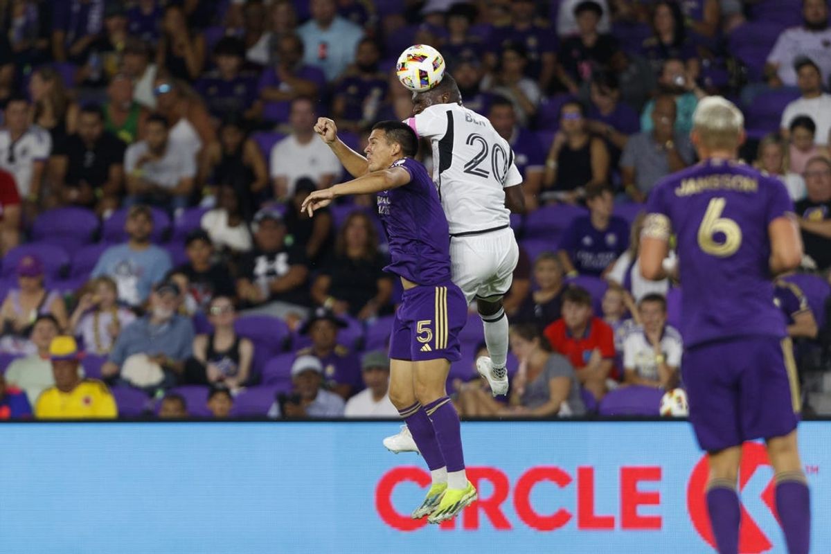 Jul 6, 2024; Orlando, Florida, USA; D.C. United forward Christian Benteke (20) wina a header over Orlando City midfielder Cesar Araujo (5) during the second half at Inter&Co Stadium. Mandatory Credit: Morgan Tencza-USA TODAY Sports