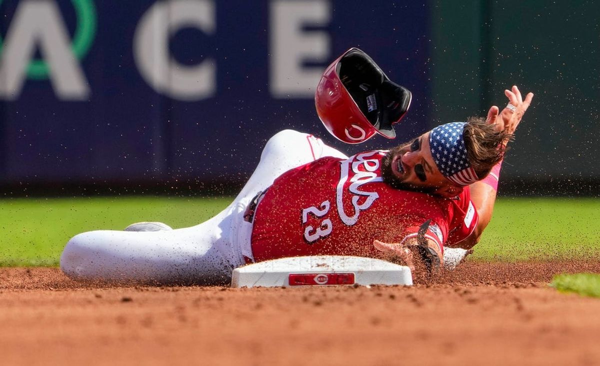 Cincinnati Reds outfielder Nick Martini (23) slides to second base after being tagged out by Detroit Tigers second base Colt Keith (33) in the 2nd inning at Great American Ball Park Saturday, July 6, 2024.