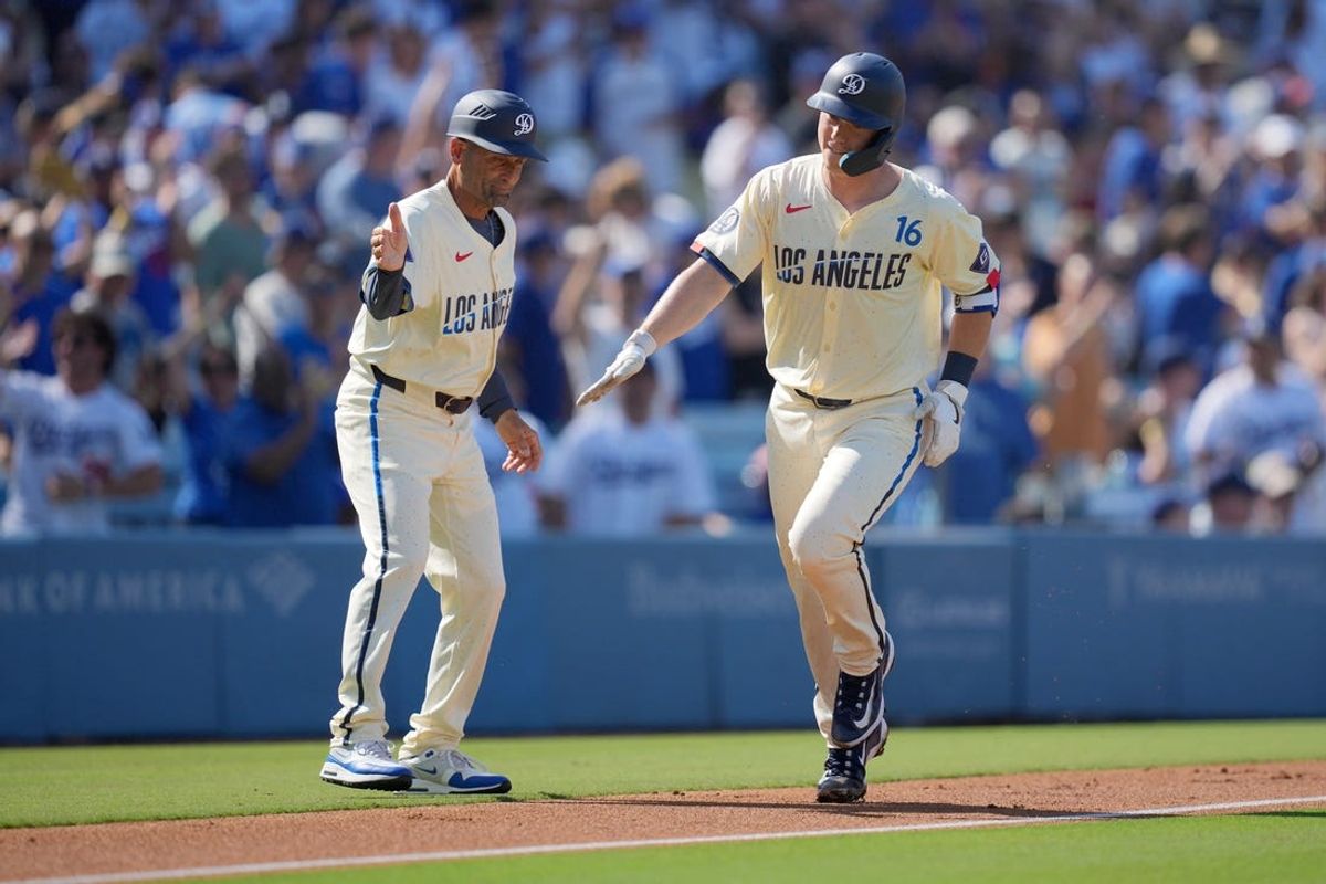 Jul 6, 2024; Los Angeles, California, USA; Los Angeles Dodgers catcher Will Smith (16) is congratulated by third base coach Dino Ebel (91) after hitting a two-run home run in the first inning against the Milwaukee Brewers at Dodger Stadium. Mandatory Credit: Kirby Lee-USA TODAY Sports