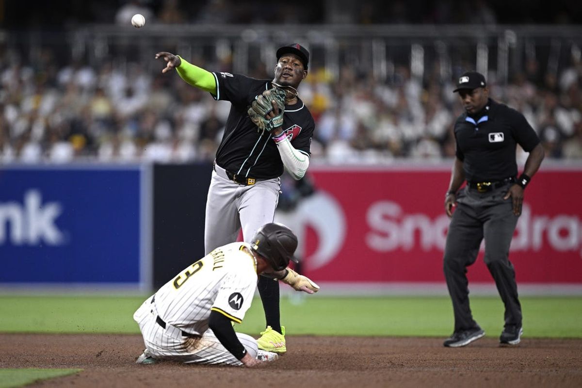 Jul 6, 2024; San Diego, California, USA; Arizona Diamondbacks shortstop Geraldo Perdomo (2) throws to first base after forcing out San Diego Padres center fielder Jackson Merrill (3) at second base to complete a double play during the fourth inning at Petco Park. Mandatory Credit: Orlando Ramirez-USA TODAY Sports