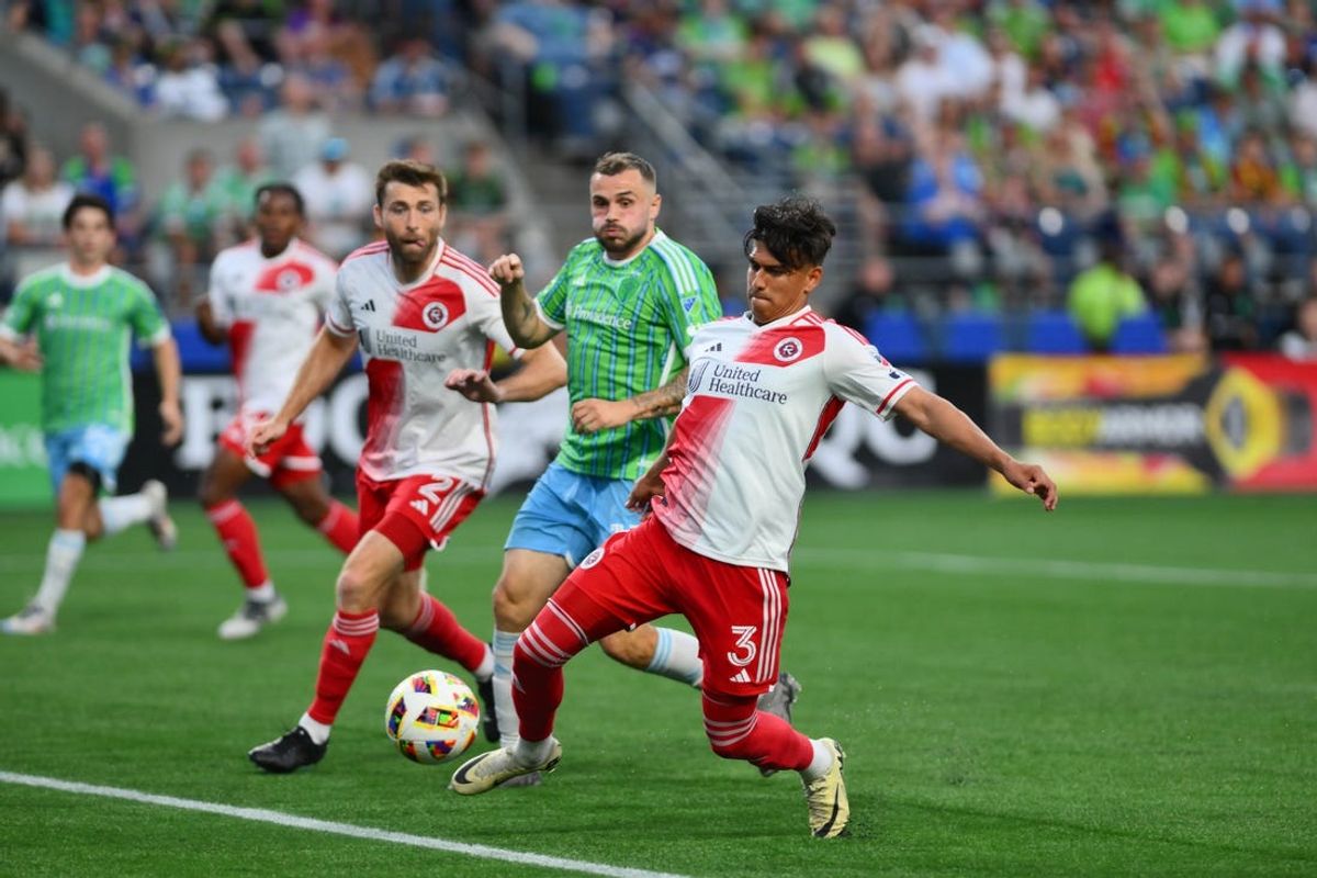 Jul 6, 2024; Seattle, Washington, USA; New England Revolution defender Xavier Arreaga (3) controls the ball against Seattle Sounders FC forward Jordan Morris (13) in the second half at Lumen Field. Mandatory Credit: Steven Bisig-USA TODAY Sports