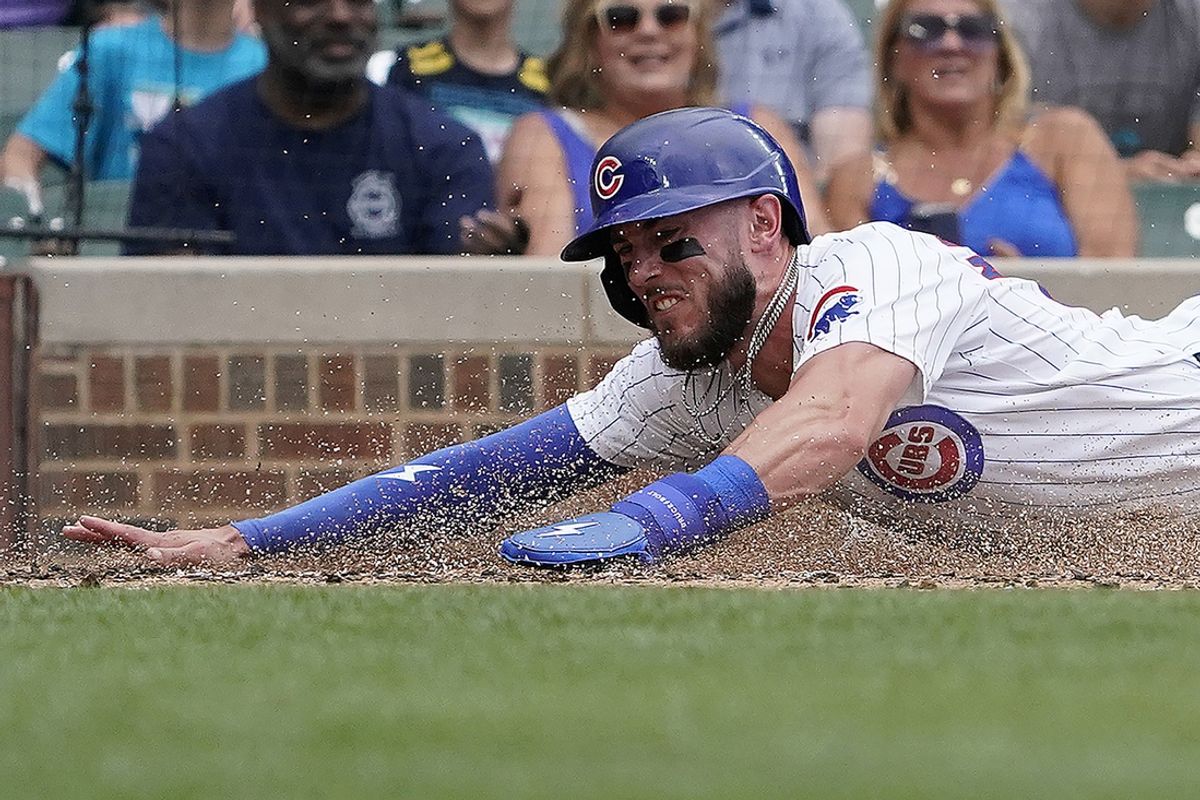 Jul 7, 2024; Chicago, Illinois, USA; Chicago Cubs third baseman Miles Mastrobuoni (20) is safe at home plate as Los Angeles Angels catcher Logan O'Hoppe (14) makes a late tag during the third inning at Wrigley Field. Mandatory Credit: David Banks-Imagn Images