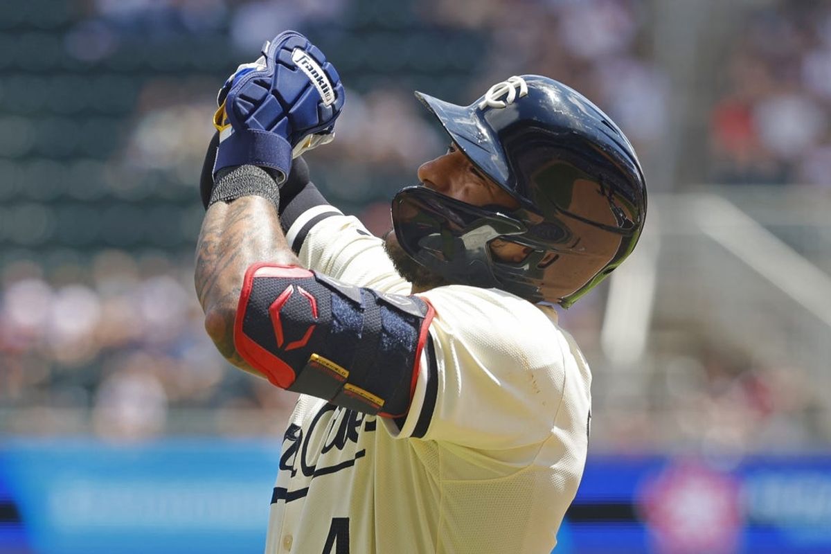 Jul 7, 2024; Minneapolis, Minnesota, USA; Minnesota Twins' Carlos Correa (4) holds up his hand after getting hit by a pitch by the Houston Astros in the first inning at Target Field. Correa left the game. Mandatory Credit: Bruce Kluckhohn-USA TODAY Sports