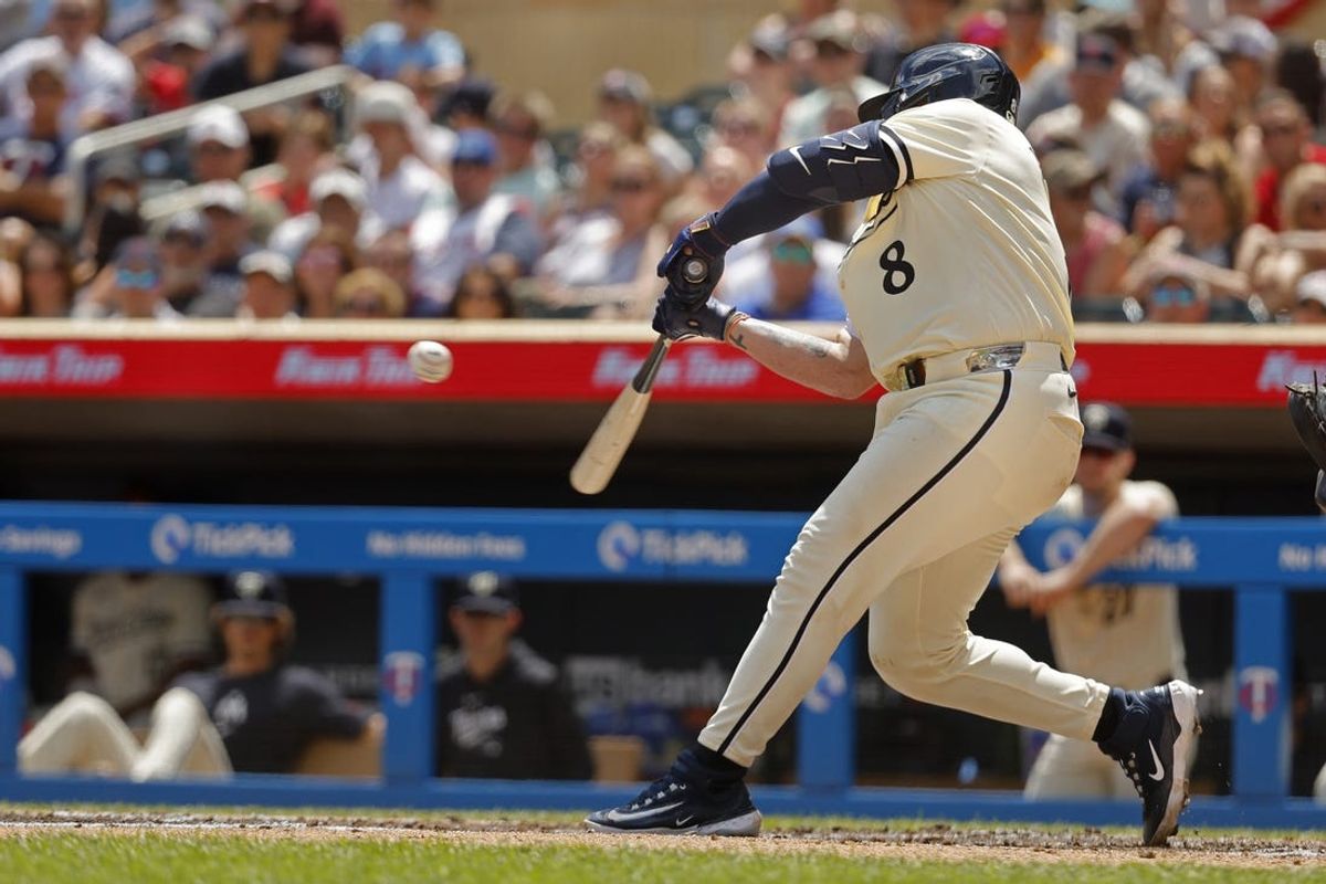 Jul 7, 2024; Minneapolis, Minnesota, USA; Minnesota Twins catcher Christian Vazquez (8) hits an RBI single against the Houston Astros in the second inning at Target Field. Mandatory Credit: Bruce Kluckhohn-USA TODAY Sports