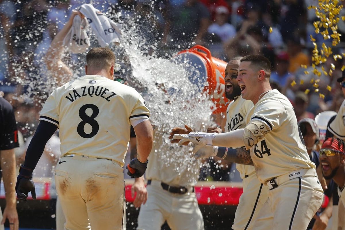 Jul 7, 2024; Minneapolis, Minnesota, USA; Minnesota Twins catcher Christian Vazquez (8) celebrates a game-winning home run against the Houston Astros with second baseman Willi Castro (50) and third baseman Jose Miranda (64) in the ninth inning at Target Field. Mandatory Credit: Bruce Kluckhohn-USA TODAY Sports