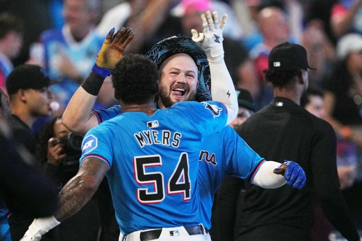 Jul 7, 2024; Miami, Florida, USA;  Miami Marlins third baseman Jake Burger, rear, celebrates a walk-off three run home run against the Chicago White Sox in the ninth inning with right fielder Dane Myers (54) at loanDepot Park. Mandatory Credit: Jim Rassol-USA TODAY Sports
