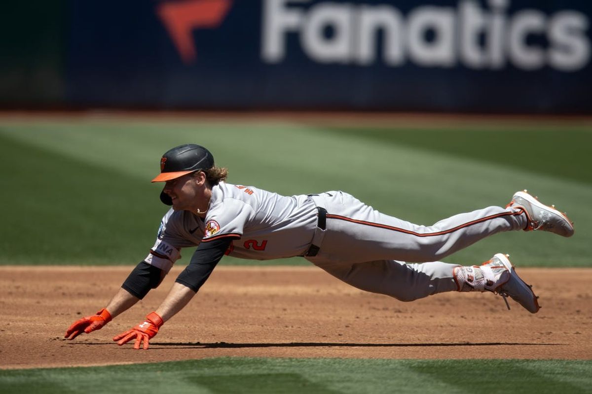 Jul 7, 2024; Oakland, California, USA; Baltimore Orioles shortstop Gunnar Henderson (2) slides nto third base with a triple during the second inning against the Oakland Athletics at Oakland-Alameda County Coliseum. Mandatory Credit: D. Ross Cameron-USA TODAY Sports