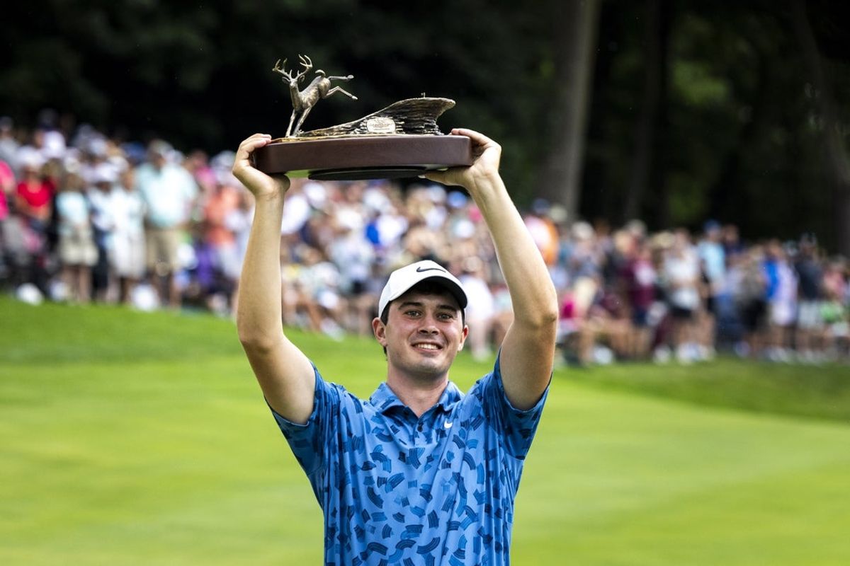 Jul 7, 2024; Silvis, Illinois, USA; Davis Thompson holds up the trophy for the John Deere Classic during the final round of the John Deere Classic golf tournament. Mandatory Credit: Joseph Cress-Imagn Images