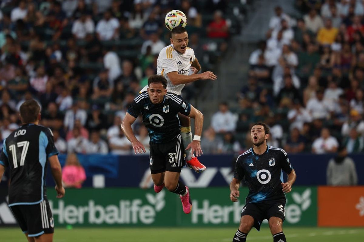 Jul 7, 2024; Carson, California, USA; Los Angeles Galaxy forward Dejan Joveljic (9) heads the ball over Minnesota United midfielder Hassani Dotson (31) in the first half at Dignity Health Sports Park. Mandatory Credit: Kiyoshi Mio-USA TODAY Sports