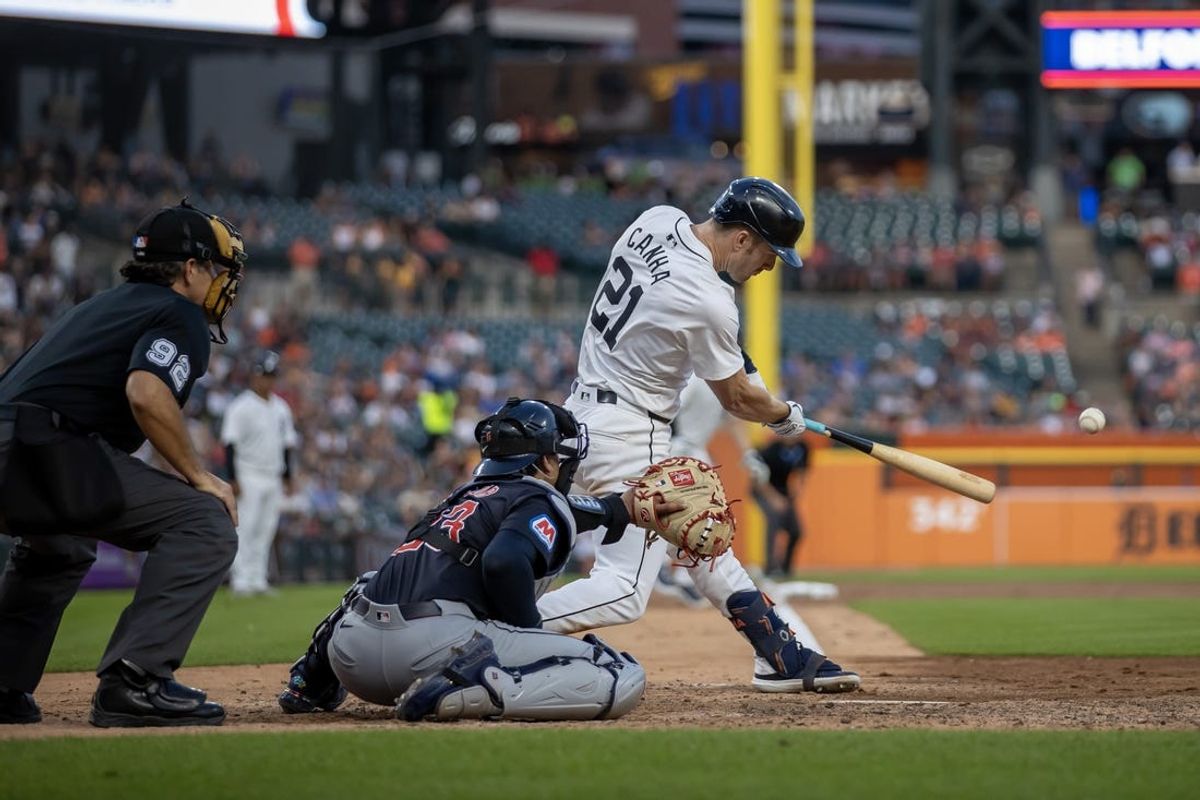 Jul 8, 2024; Detroit, Michigan, USA; Detroit Tigers outfielder Mark Canha (21) hits an infielders choice RBI in the eighth inning against the Cleveland Guardians at Comerica Park. Mandatory Credit: David Reginek-USA TODAY Sports