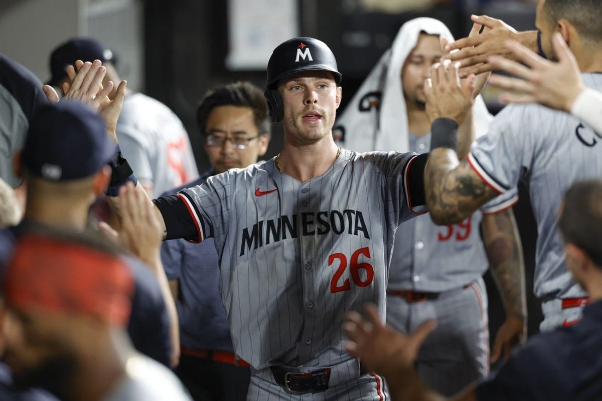 Jul 8, 2024; Chicago, Illinois, USA; Minnesota Twins outfielder Max Kepler (26) celebrates with teammates in the dugout after scoring against the Chicago White Sox during the 11th inning at Guaranteed Rate Field. Mandatory Credit: Kamil Krzaczynski-USA TODAY Sports
