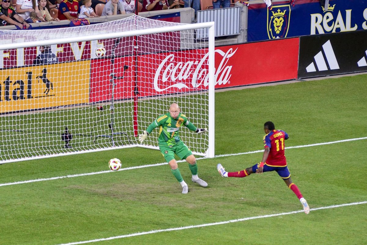 Jul 6, 2024; Sandy, Utah, USA; Real Salt Lake midfielder Andres Gomez (11) attempted shot on goal against Atlanta United goalkeeper Brad Guzan (1) during the second half at America First Field. Mandatory Credit: Christopher Creveling-USA TODAY Sports