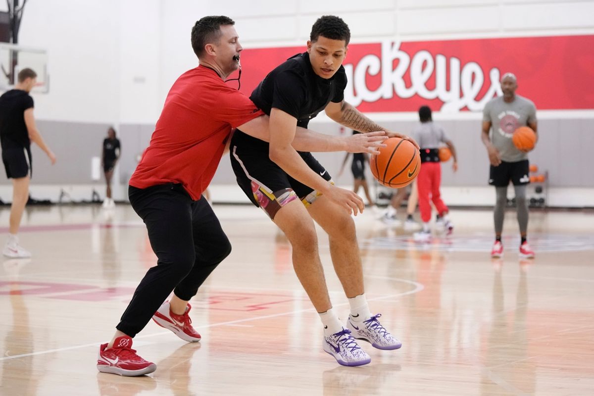 Jul 9, 2024; Columbus, OH, USA; Ohio State Buckeyes head coach Jake Diebler defends guard John Mobley Jr. during a summer workout in the practice gym at the Schottenstein Center.