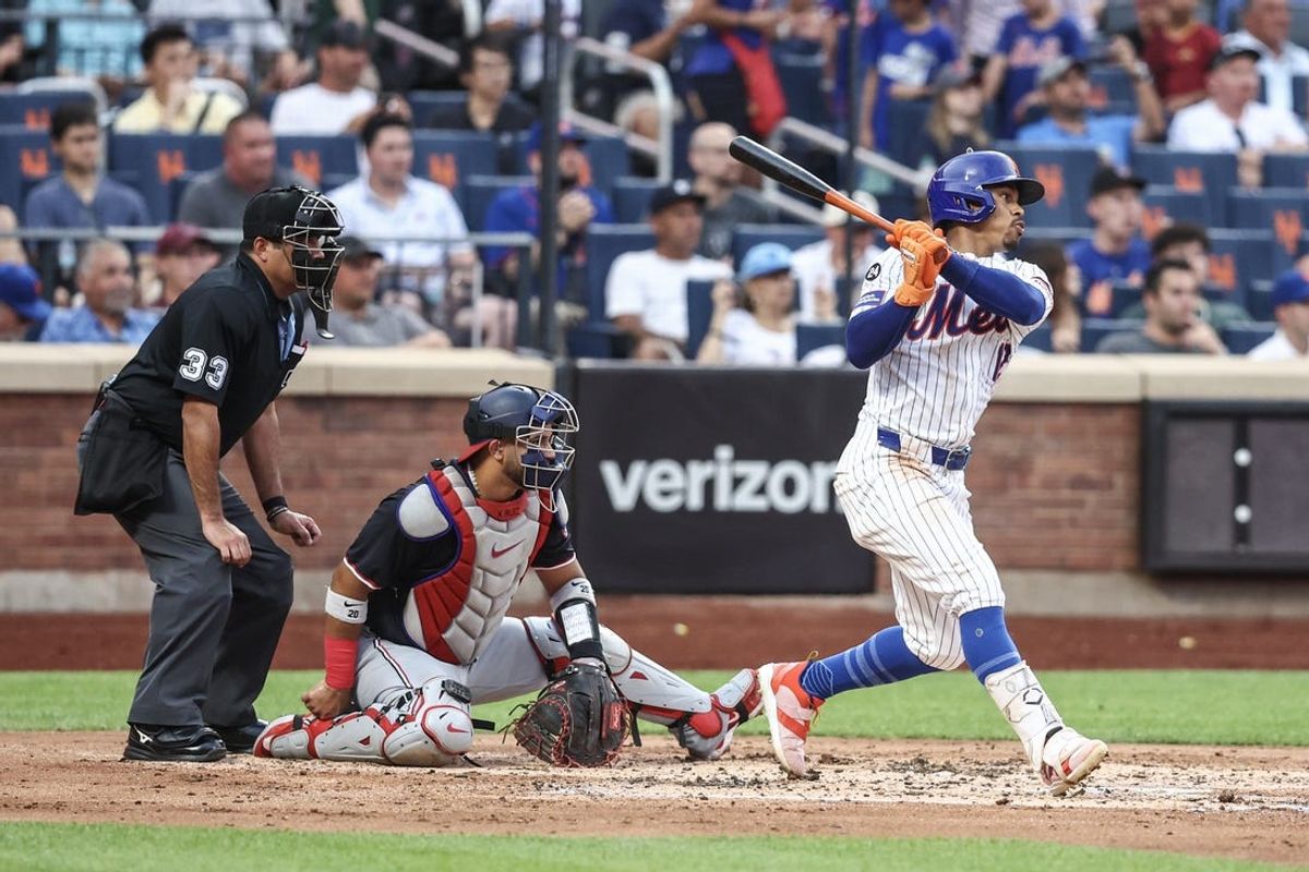 Jul 9, 2024; New York City, New York, USA;  New York Mets shortstop Francisco Lindor (12) hits a RBI single in the second inning against the Washington Nationals at Citi Field. Mandatory Credit: Wendell Cruz-USA TODAY Sports
