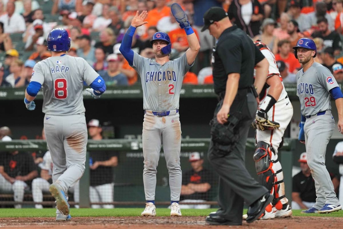 Jul 9, 2024; Baltimore, Maryland, USA; Chicago Cubs outfielder Ian Happ (8) greeted by second baseman Nico Hoerner (2) and first baseman Michael Busch (29) following his three run home run in the fourth inning against the Baltimore Orioles at Oriole Park at Camden Yards. Mandatory Credit: Mitch Stringer-USA TODAY Sports