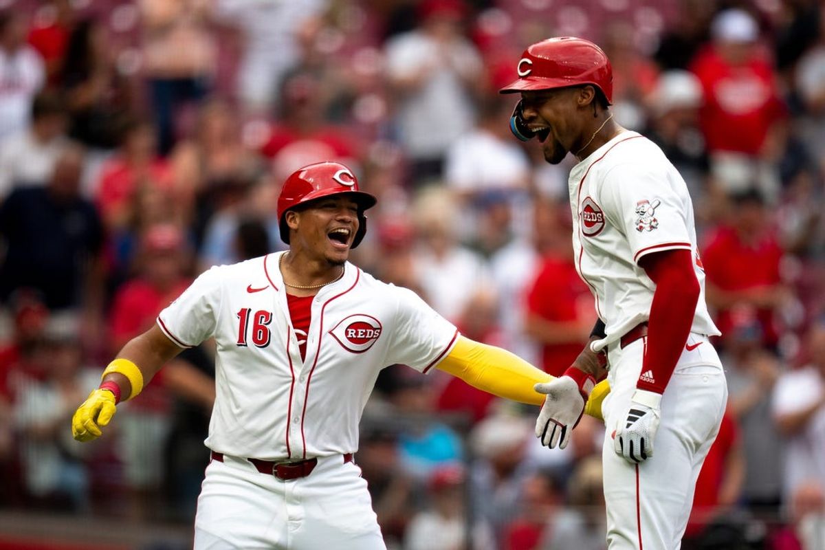 Cincinnati Reds outfielder Will Benson (30) reacts as he crosses home plate with Cincinnati Reds third baseman Noelvi Marte (16) after hitting a 3-run home run in the second inning of the MLB game between Cincinnati Reds and Colorado Rockies at Great American Ball Park in Cincinnati on Tuesday, July 9, 2024.