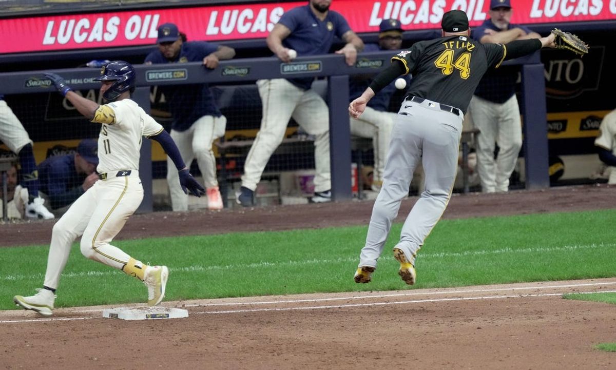 Milwaukee Brewers outfielder Jackson Chourio (11) reaches first base on a throwing errror as Pittsburgh Pirates first base Rowdy Tellez (44) in unable to catch the ball during the third inning of their game Tuesday, July 9, 2024 at American Family Field in Milwaukee, Wisconsin.