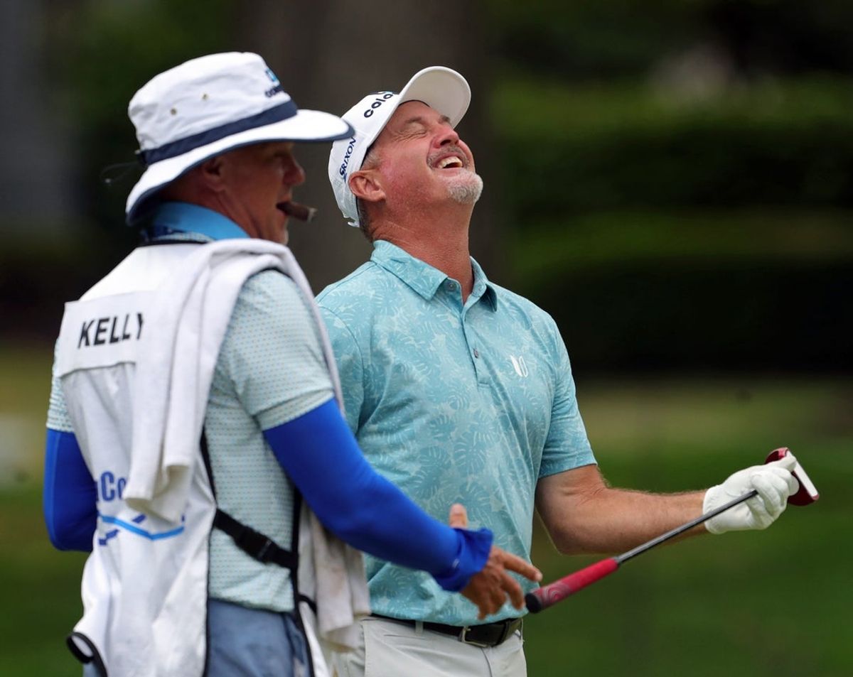 Jerry Kelly, right, shares a laugh with his caddy on the 16th hole during the Kaulig Companies Championship pro-am at Firestone Country Club, Wednesday, July 10, 2024, in Akron, Ohio.