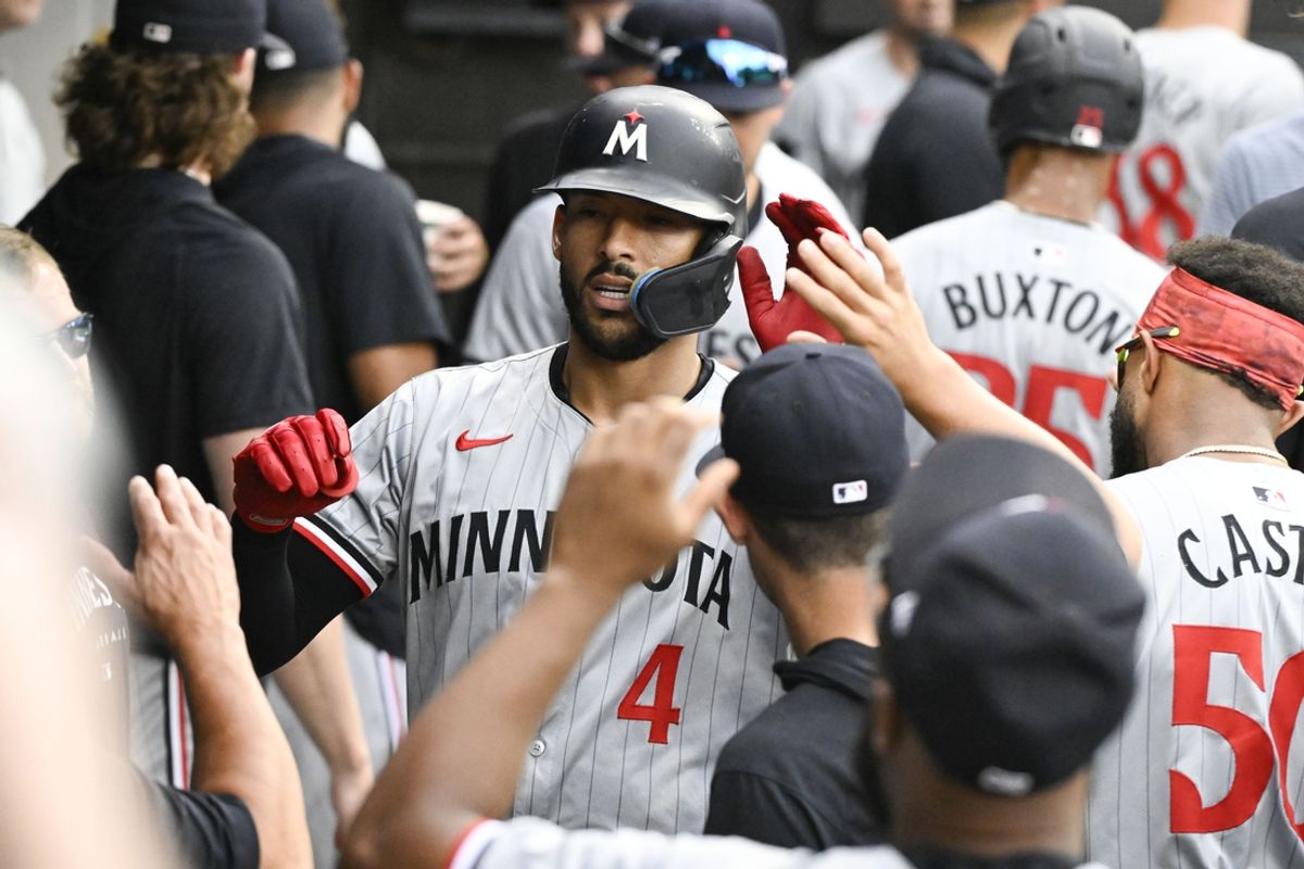 Jul 10, 2024; Chicago, Illinois, USA;  Minnesota Twins shortstop Carlos Correa (4) celebrates in the dugout after hitting a home run against the Chicago White Sox during the sixth inning at Guaranteed Rate Field. Mandatory Credit: Matt Marton-Imagn Images