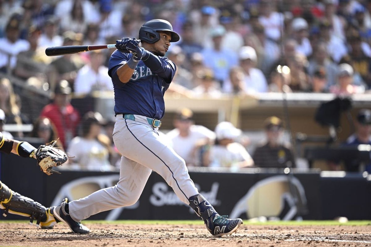 Jul 10, 2024; San Diego, California, USA; Seattle Mariners second baseman Jorge Polanco (7) hits a RBI single against the San Diego Padres during the fourth inning at Petco Park. Mandatory Credit: Orlando Ramirez-USA TODAY Sports