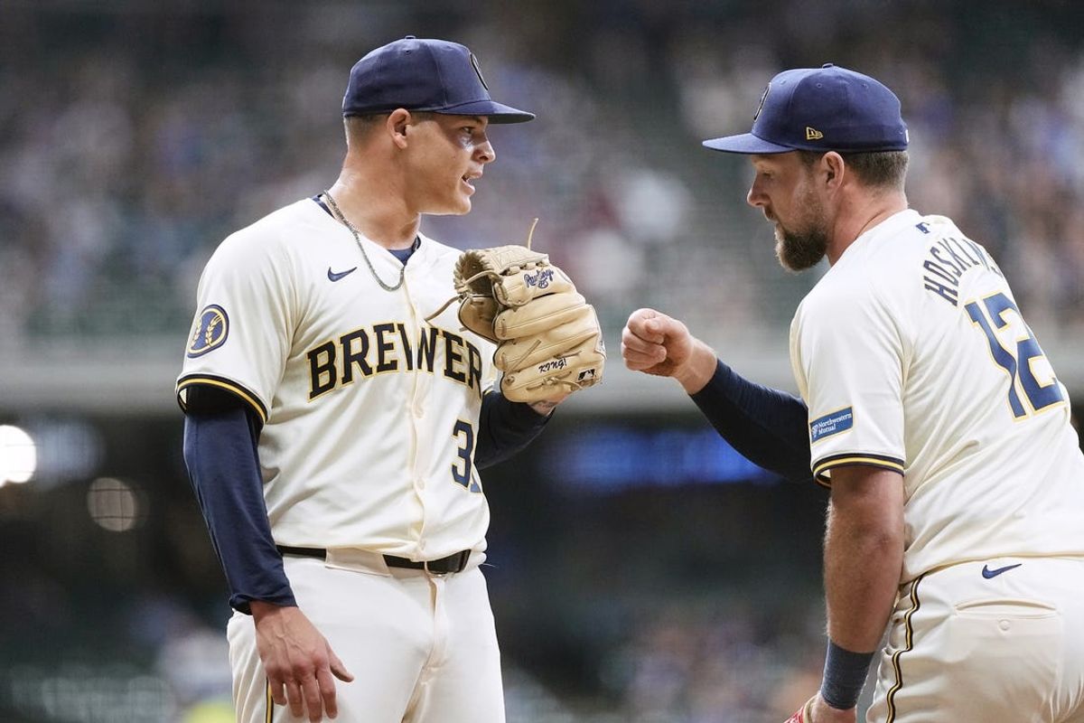 Jul 10, 2024; Milwaukee, Wisconsin, USA;  Milwaukee Brewers pitcher Tobias Myers (36) celebrates wth first baseman Rhys Hoskins (12) following a double play to end the top of the seventh inning against the Pittsburgh Pirates at American Family Field. Mandatory Credit: Jeff Hanisch-USA TODAY Sports