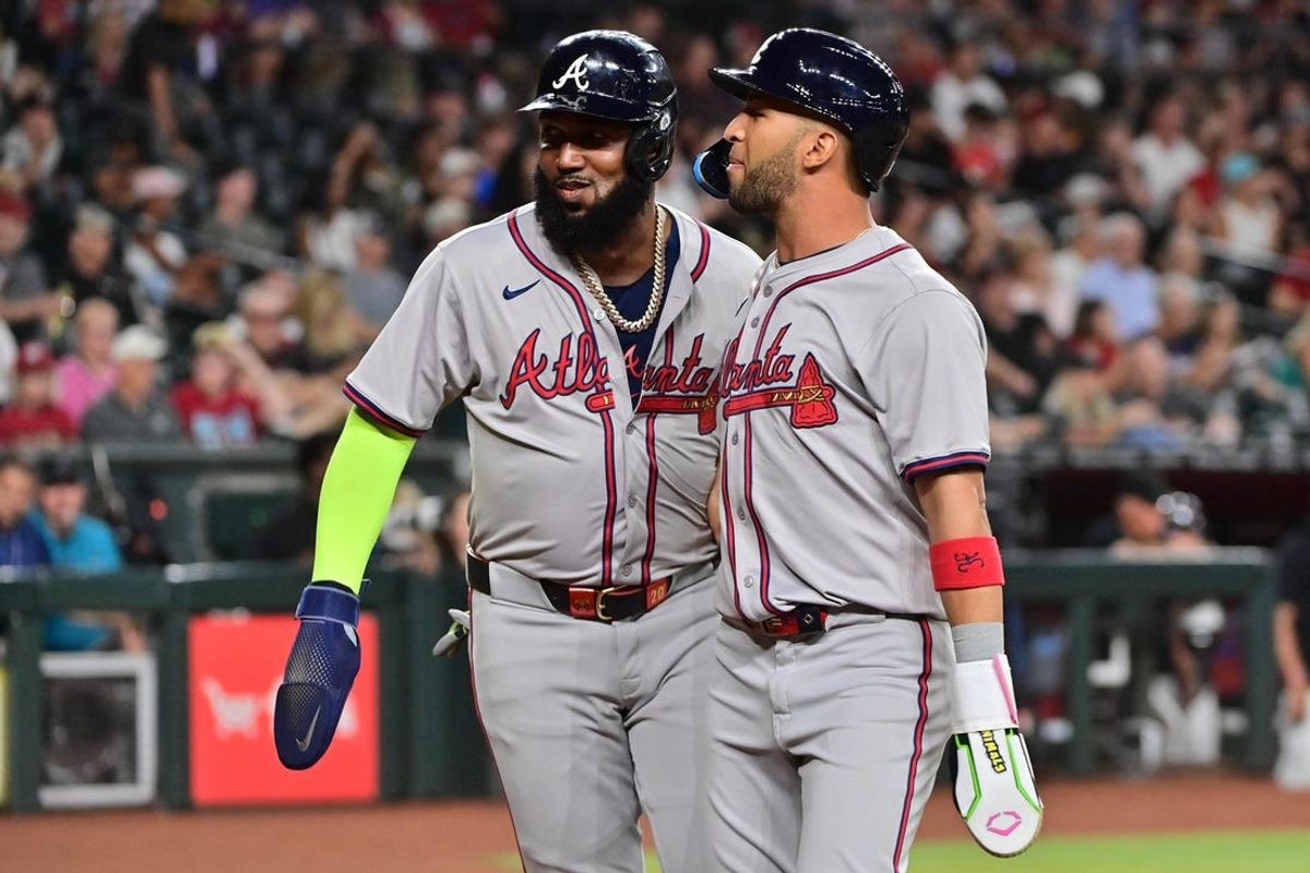 Jul 10, 2024; Phoenix, Arizona, USA;  Atlanta Braves outfielder Eddie Rosario (8) and designated hitter Marcell Ozuna (20) celebrate after scoring in the second inning against the Arizona Diamondbacks at Chase Field. Mandatory Credit: Matt Kartozian-USA TODAY Sports