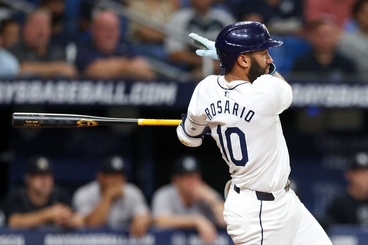 Jul 11, 2024; St. Petersburg, Florida, USA; Tampa Bay Rays second baseman Amed Rosario (10) hits an RBI double against the New York Yankees in the second inning at Tropicana Field. Mandatory Credit: Nathan Ray Seebeck-USA TODAY Sports