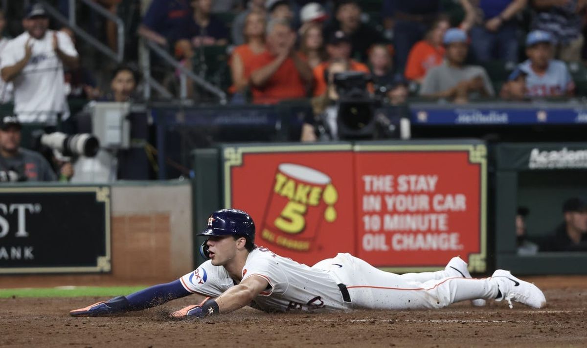 Jul 11, 2024; Houston, Texas, USA; Houston Astros left fielder Joey Loperfido (10) slides safely at home plate against the Miami Marlins in the fourth inning at Minute Maid Park. Mandatory Credit: Thomas Shea-USA TODAY Sports