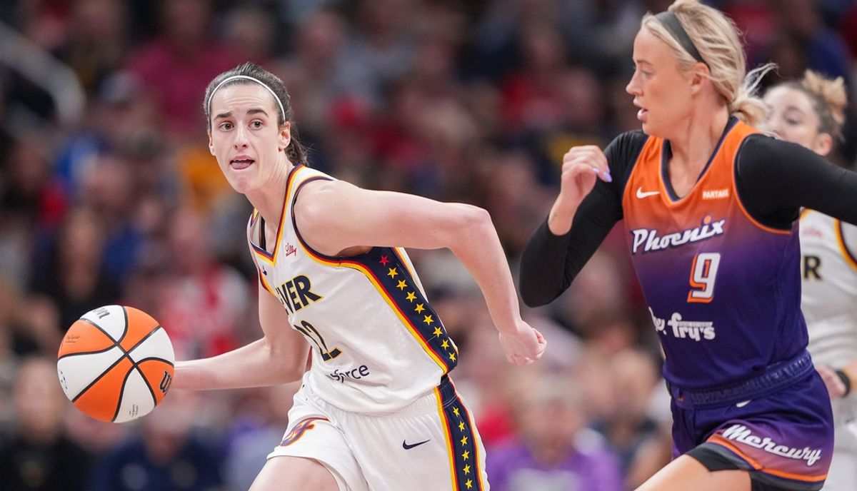 Indiana Fever guard Caitlin Clark (22) rushes up the court against Phoenix Mercury guard Sophie Cunningham (9) on Friday, July 12, 2024, during the game at Gainbridge Fieldhouse in Indianapolis.