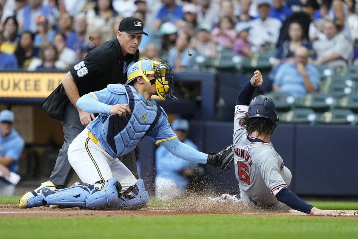 Jul 12, 2024; Milwaukee, Wisconsin, USA;  Milwaukee Brewers catcher William Contreras (24) tags out Washington Nationals designated hitter Jesse Winker (6) on a play at the plate during the first inning at American Family Field. Mandatory Credit: Jeff Hanisch-USA TODAY Sports