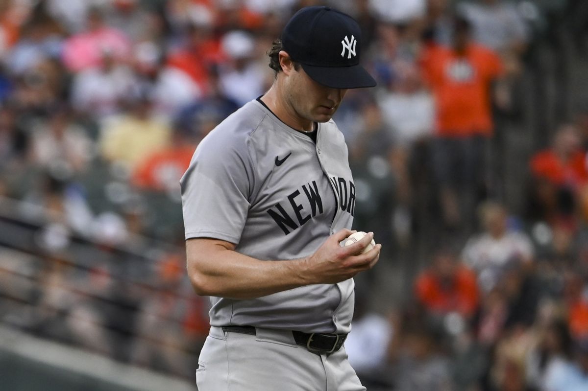 Jul 12, 2024; Baltimore, Maryland, USA;  New York Yankees pitcher Gerrit Cole (45) looks at the baseball on the pitcher's mound during the first inning against the Baltimore Orioles at Oriole Park at Camden Yards. Mandatory Credit: Tommy Gilligan-USA TODAY Sports