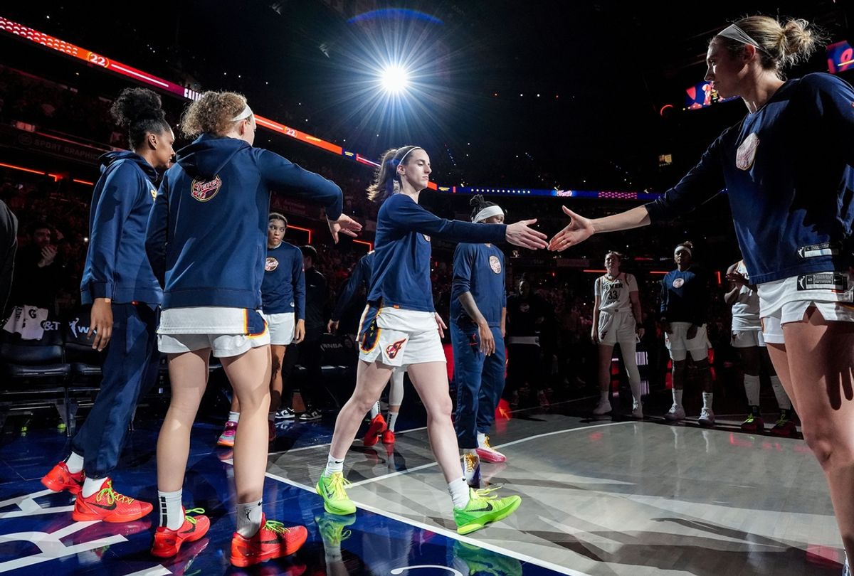 Indiana Fever guard Caitlin Clark (22) shakes hands with Indiana Fever guard Lexie Hull (10) during team introductions on Friday, July 12, 2024, during the game at Gainbridge Fieldhouse in Indianapolis. The Indiana Fever defeated the Phoenix Mercury, 95-86.