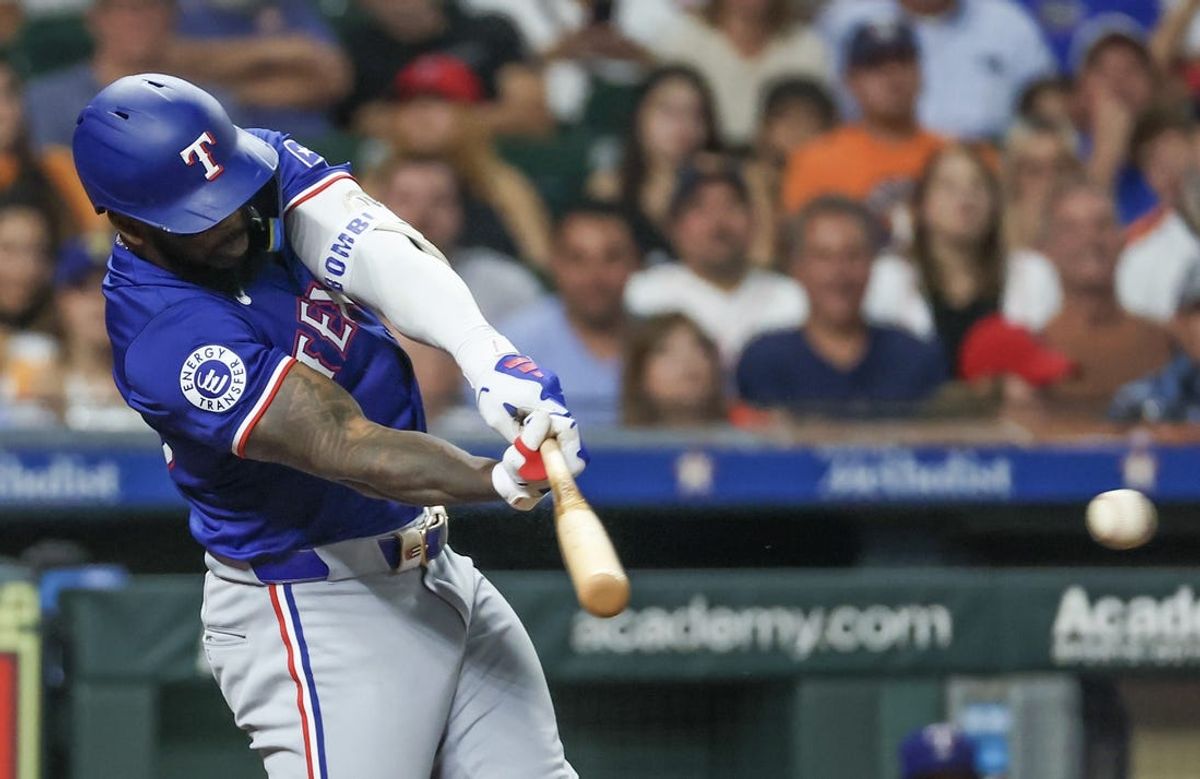 Jul 12, 2024; Houston, Texas, USA; Texas Rangers right fielder Adolis Garcia (53) hits a single against the Houston Astros in the sixth inning at Minute Maid Park. Mandatory Credit: Thomas Shea-USA TODAY Sports