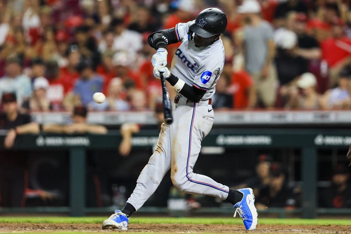 Jul 12, 2024; Cincinnati, Ohio, USA; Miami Marlins outfielder Nick Gordon (1) hits a double in the ninth inning against the Cincinnati Reds at Great American Ball Park. Mandatory Credit: Katie Stratman-Imagn Images