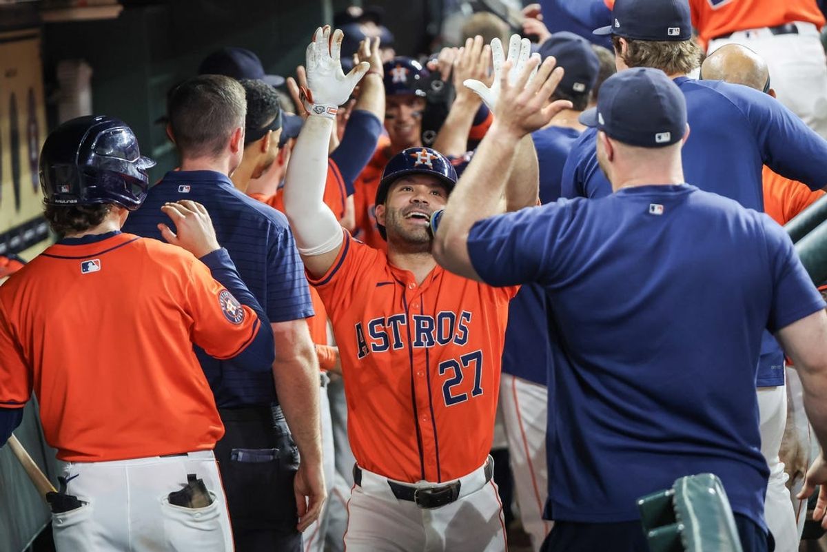 Jul 12, 2024; Houston, Texas, USA;  Houston Astros second baseman Jose Altuve (27) celebrates his three run home run in the dugout with teammates in the sixth inning against the Texas Rangers at Minute Maid Park. Mandatory Credit: Thomas Shea-USA TODAY Sports