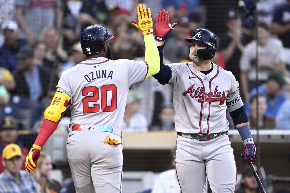 Jul 12, 2024; San Diego, California, USA; Atlanta Braves designated hitter Marcell Ozuna (20) is congratulated by right fielder Adam Duvall (14) after hitting a home run against the San Diego Padres during the fifth inning at Petco Park. Mandatory Credit: Orlando Ramirez-USA TODAY Sports