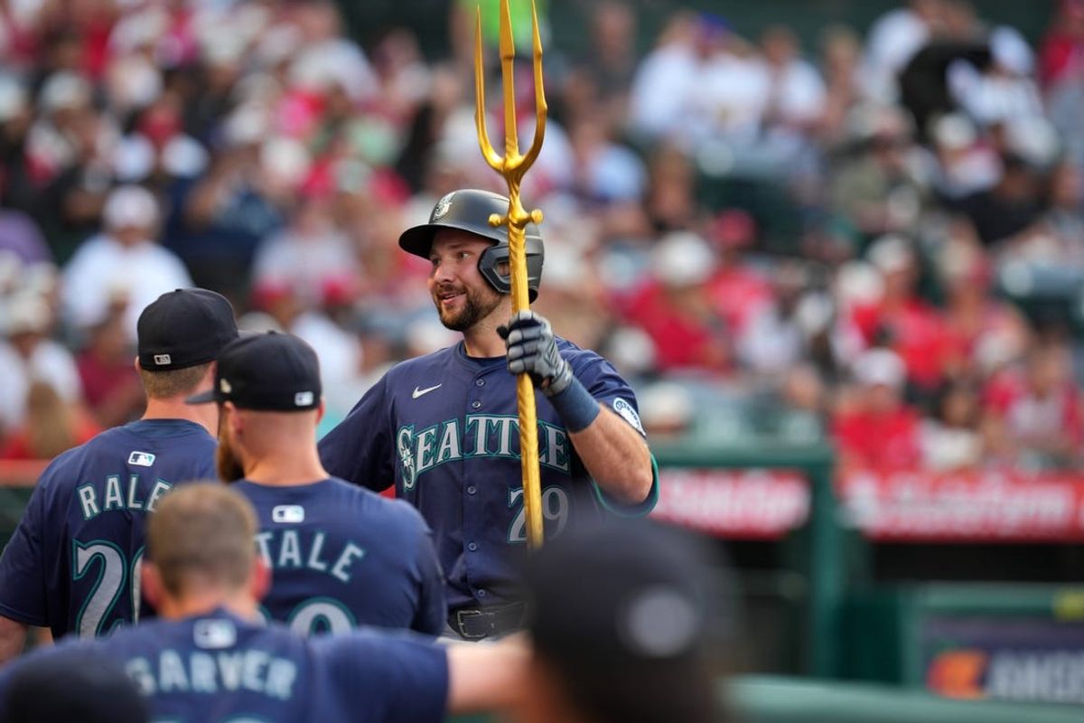 Jul 12, 2024; Anaheim, California, USA; Seattle Mariners catcher Cal Raleigh (29) celebrates with pitchfork after hitting a two-run home run in the third inning against the Los Angeles Angels at Angel Stadium. Mandatory Credit: Kirby Lee-USA TODAY Sports