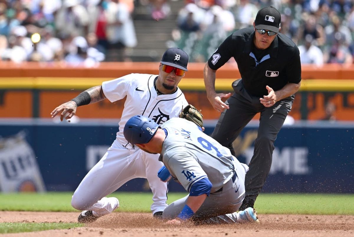 Jul 13, 2024; Detroit, Michigan, USA; Detroit Tigers shortstop Javier Báez (28) tags out Los Angeles Dodgers second base Gavin Lux (9) on a steal attempt at second base in the second inning at Comerica Park. Mandatory Credit: Lon Horwedel-USA TODAY Sports