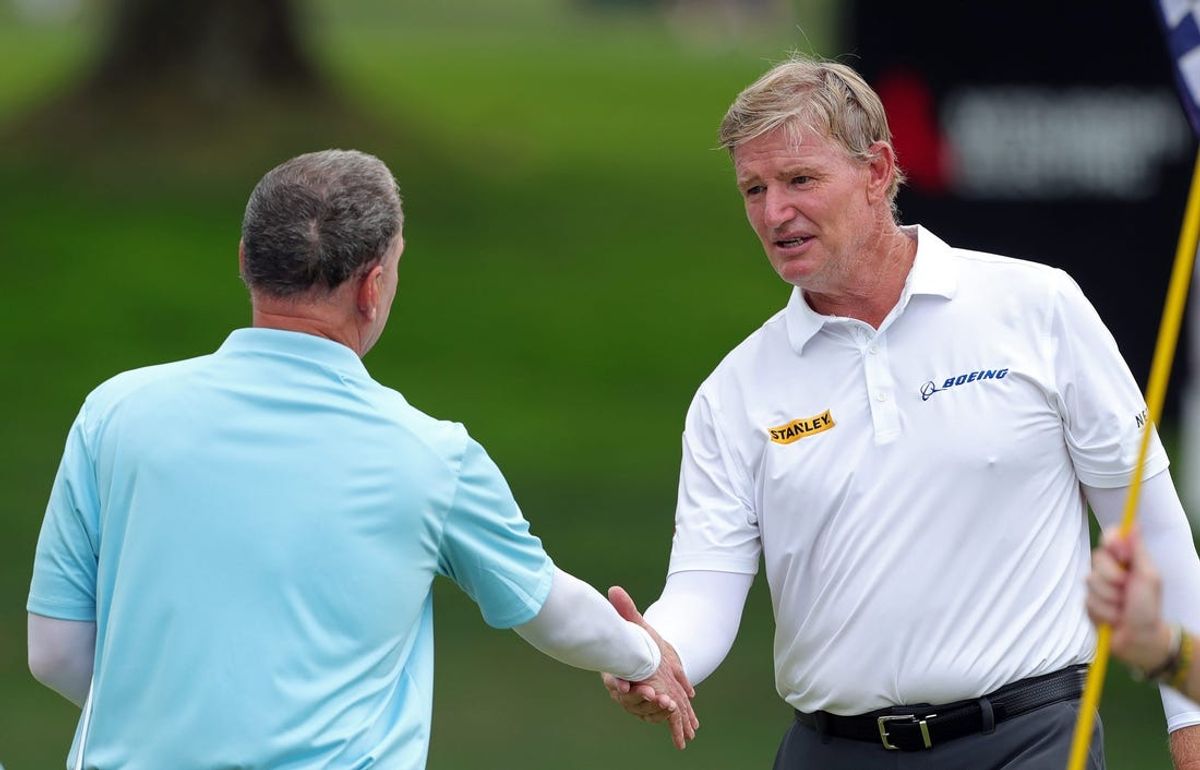 Ernie Els, facing, shakes hands with his group mates after completing the third round of the Kaulig Companies Championship at Firestone Country Club, Saturday, July 13, 2024, in Akron, Ohio.