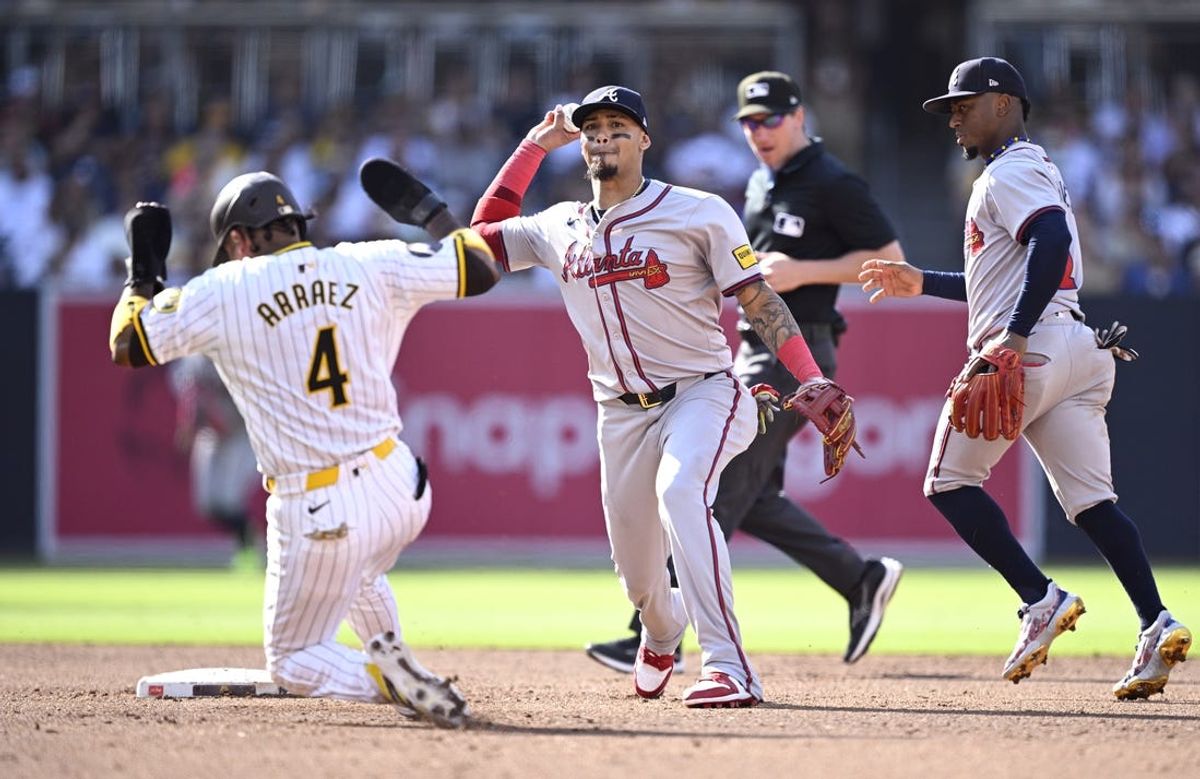 Jul 13, 2024; San Diego, California, USA; Atlanta Braves shortstop Orlando Arcia (11) throws to first base after forcing out San Diego Padres first baseman Luis Arraez (4) at second base to complete a double play during the third inning at Petco Park. Mandatory Credit: Orlando Ramirez-USA TODAY Sports